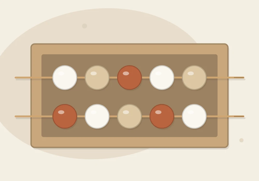 Round clay beads threaded on two wooden skewers resting across the rim of an open box so the beads dry without flat spots