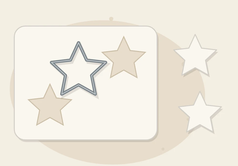A star cutter pressed into a clay slab with two cut stars already lifted out beside it