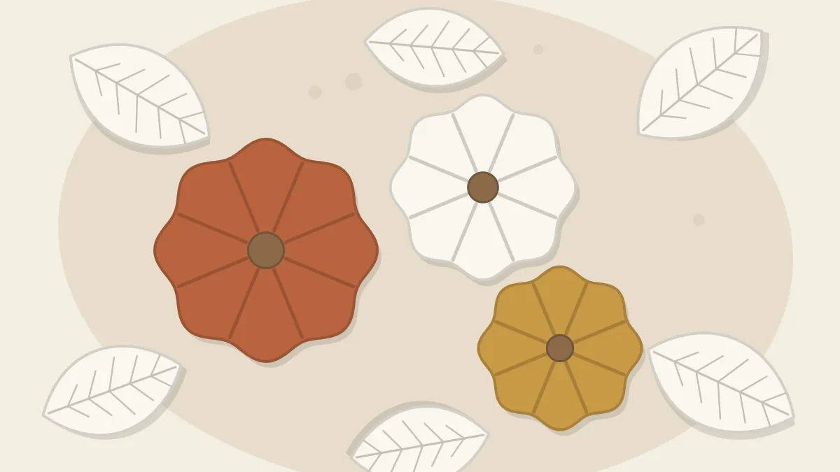Three mini clay pumpkins in terracotta, white and mustard with small stems, surrounded by flat clay leaves, seen from above