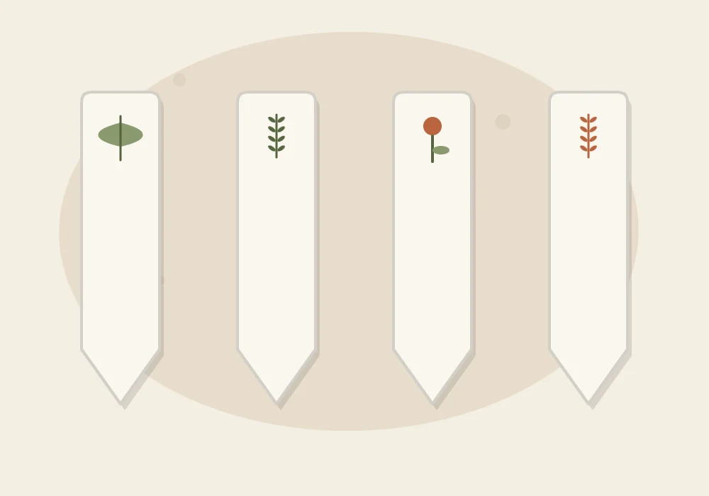 Four finished plant markers lying flat in a row, each decorated with a simple painted leaf or sprig symbol