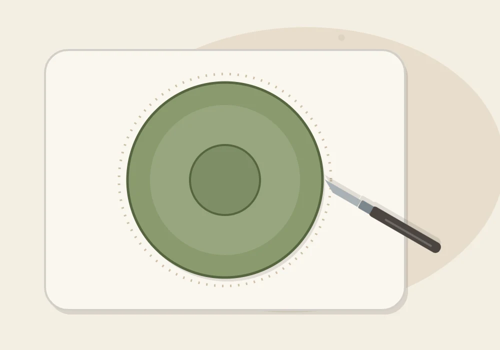 A craft knife cutting a circle out of a clay slab around an upturned bowl used as a template