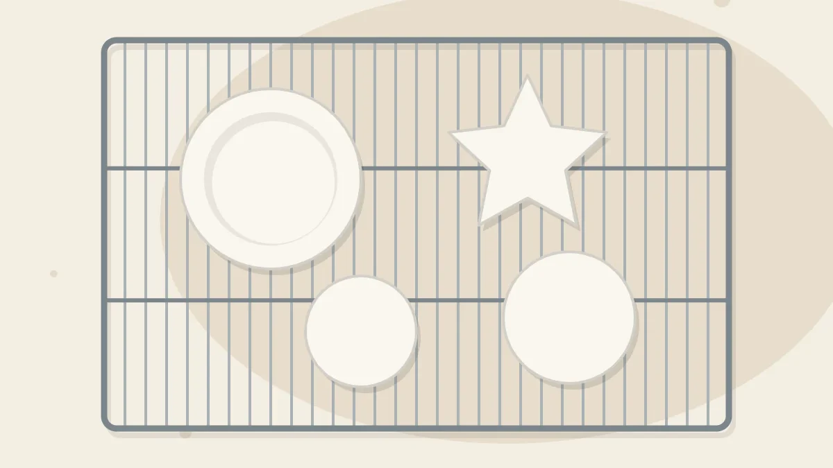 Several small clay pieces - a dish, a star and two discs - drying on a metal wire rack, seen from above