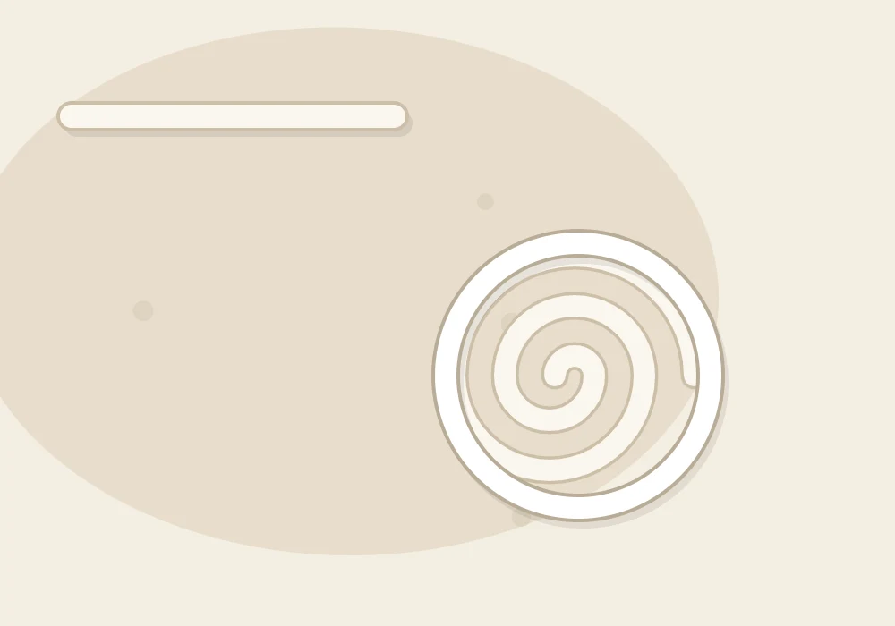 Long clay coils: one rolled out straight and one wound into a flat spiral base with a second ring stacked on its edge